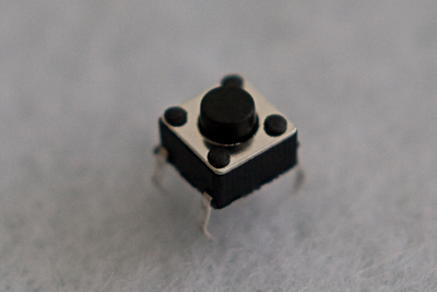 A momentary switch, or push button